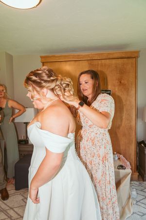 Final hair styling preparations taking place before a wedding ceremony.