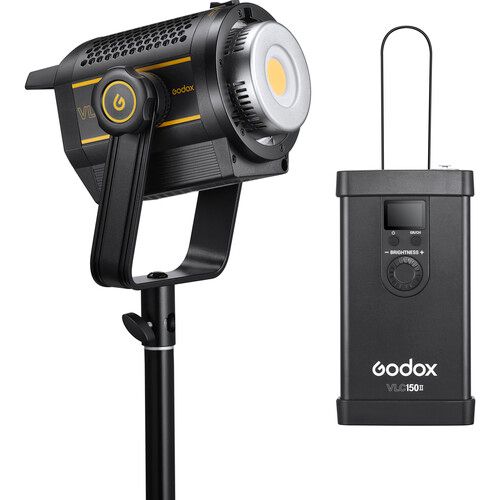 Professional LED video light with Godox power pack attachment showing black metal construction and orange accents.