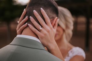Bride rests her hand against head in a tender emotional moment during an outdoor wedding in albuquerque New Mexico. ABQ wedding photographer