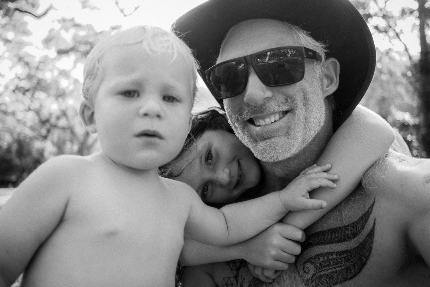 Black and white series of intimate family portraits outdoors.
