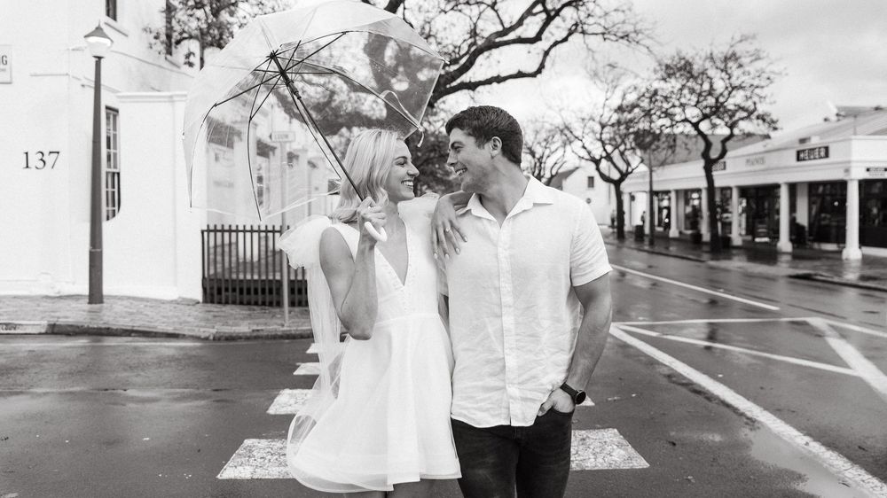A series of black and white wedding photos set outdoors and indoors showing joyful moments and tender embraces.