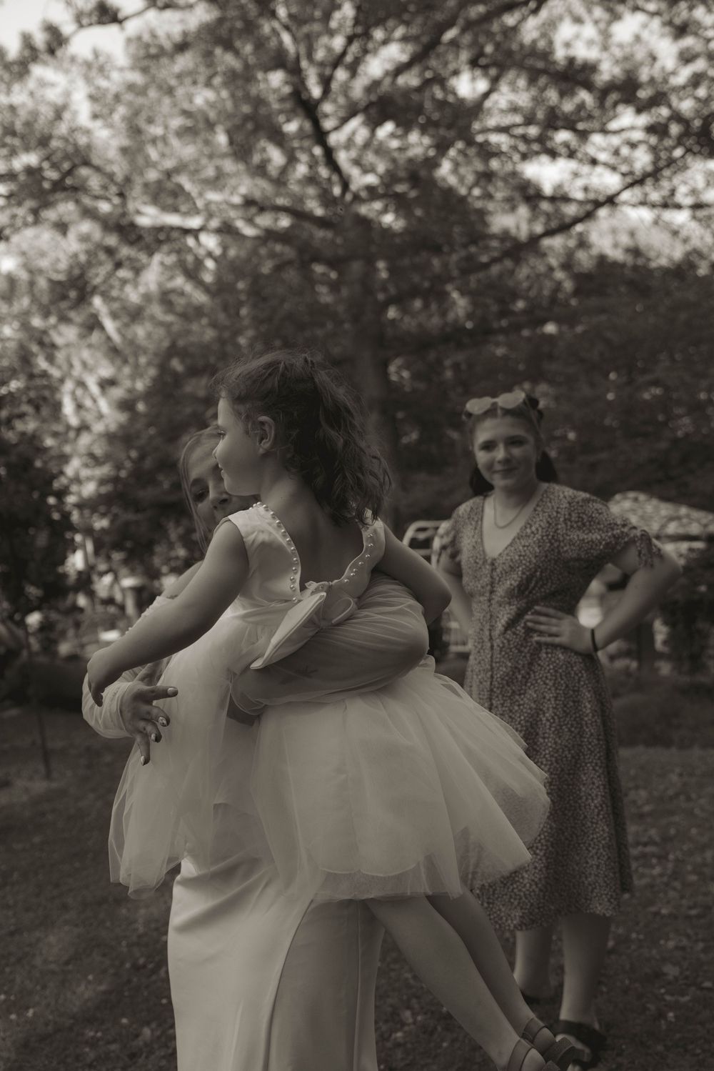A tender moment captured in black and white photography outdoors.