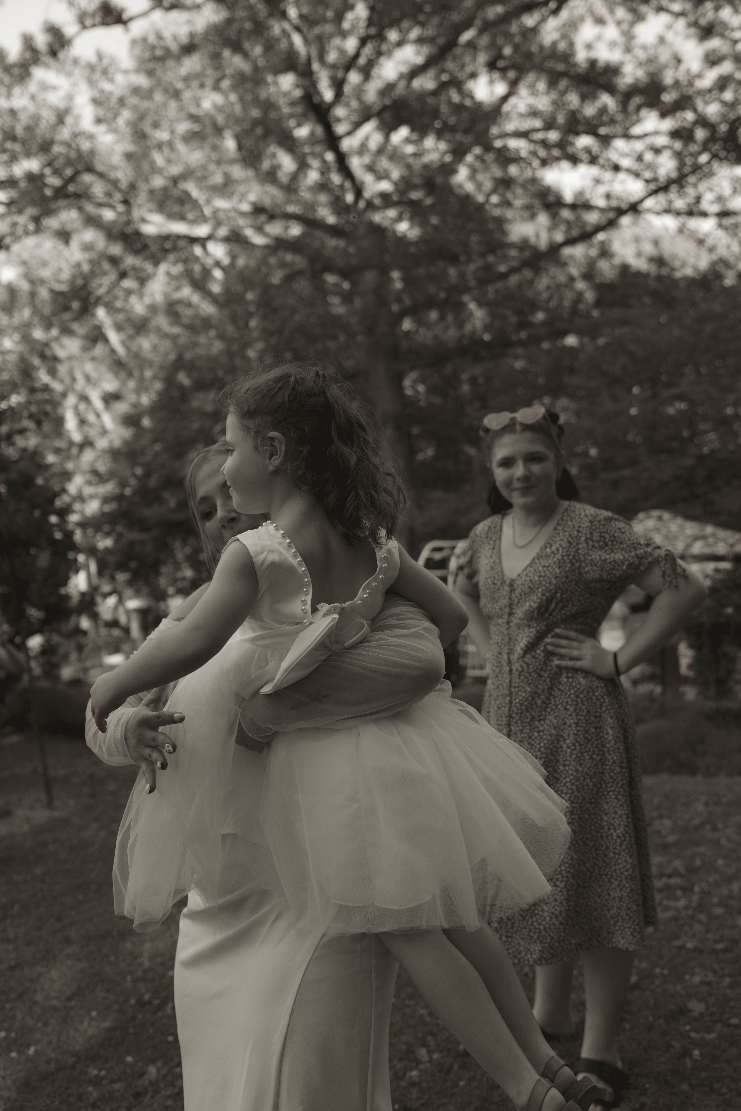 A tender moment captured in black and white photography outdoors.