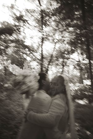 An artistic blurred black and white photo capturing movement in a forest setting.