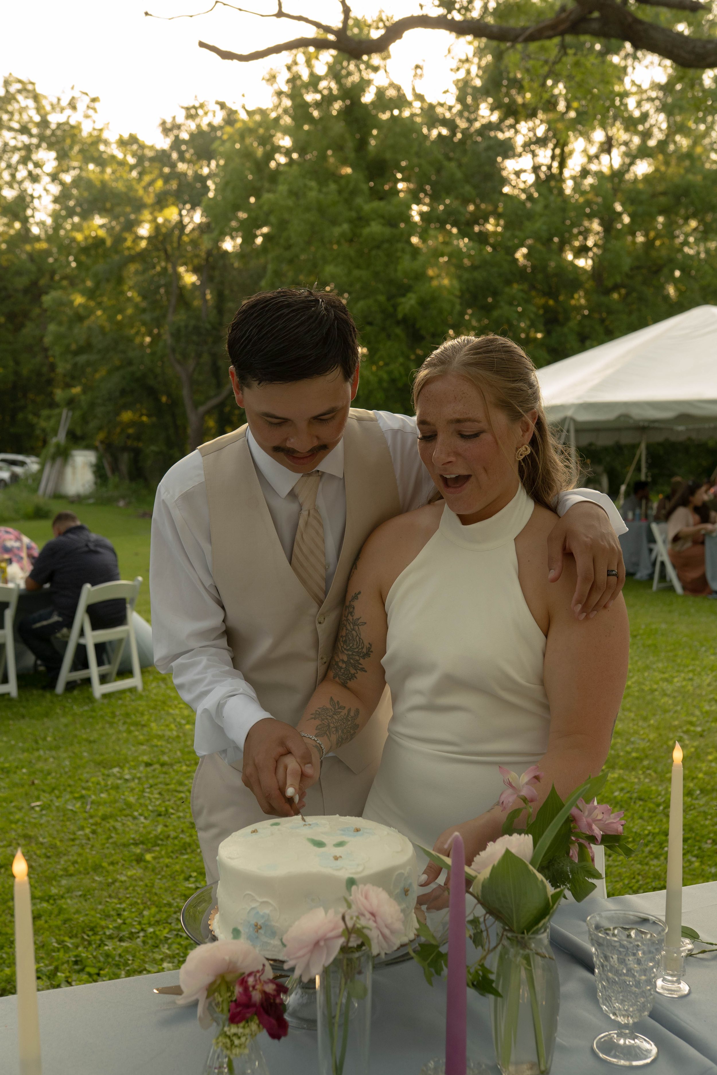 Couple sharing an intimate moment at their outdoor wedding reception.