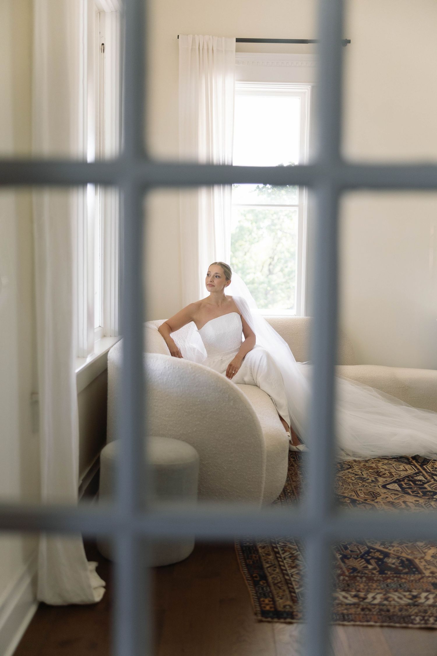 Three photos show a figure rolling across a patterned rug in a bright room, seen through vertical bars.