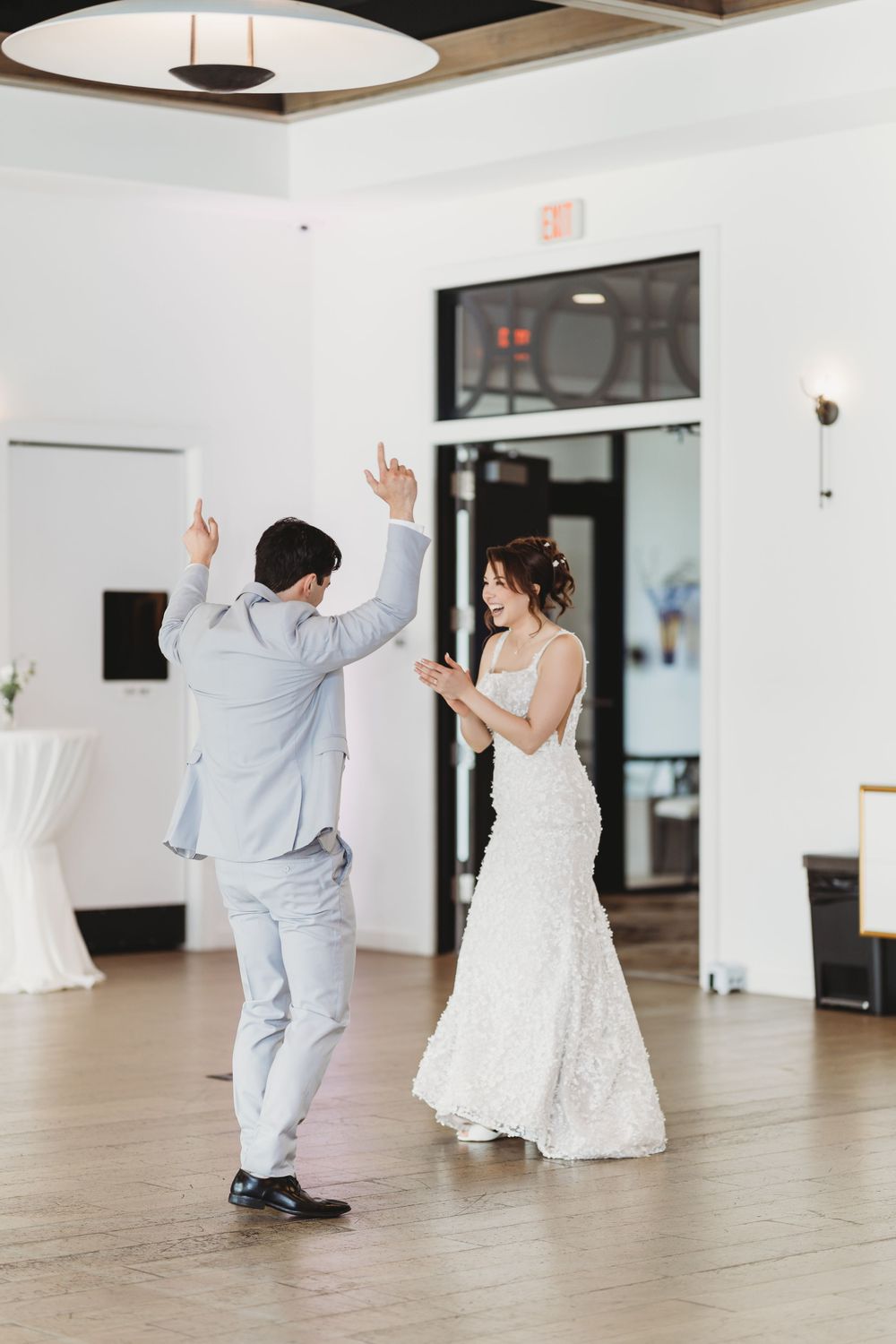 A beautiful dance sequence between two people shown as a sequence of five connected photos in a modern white room.