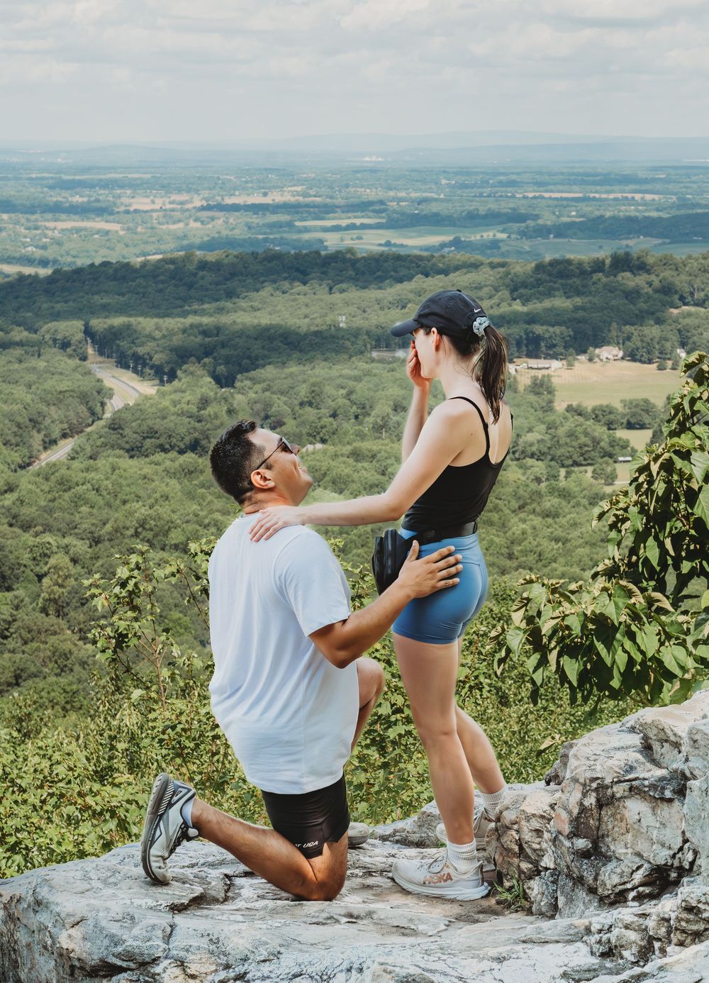 A marriage proposal sequence captured at a scenic mountain overlook showing emotions progressing through multiple frames.