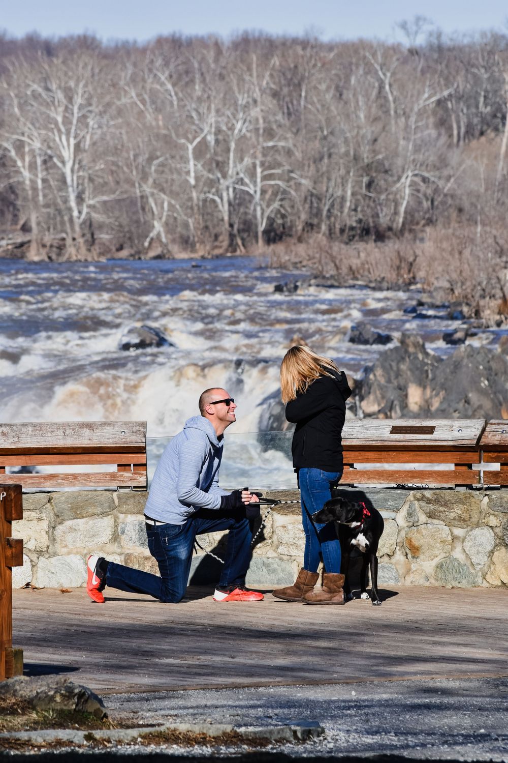 A sequence showing a marriage proposal at a scenic overlook by a rushing river on a winter day.