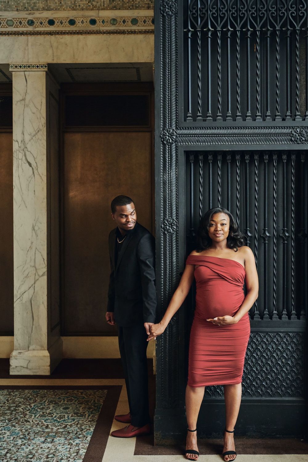 A creative maternity photo series showing a figure in a coral dress posing against an ornate dark doorway in different positions.