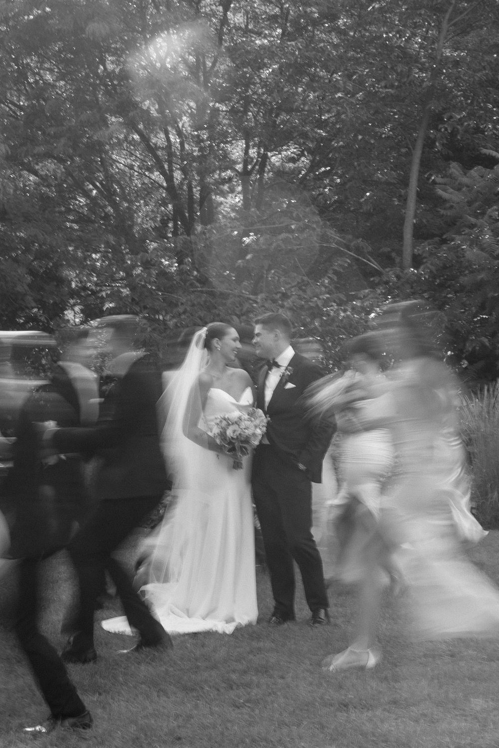 A black and white motion blur sequence shows a wedding couple dancing outdoors surrounded by guests.