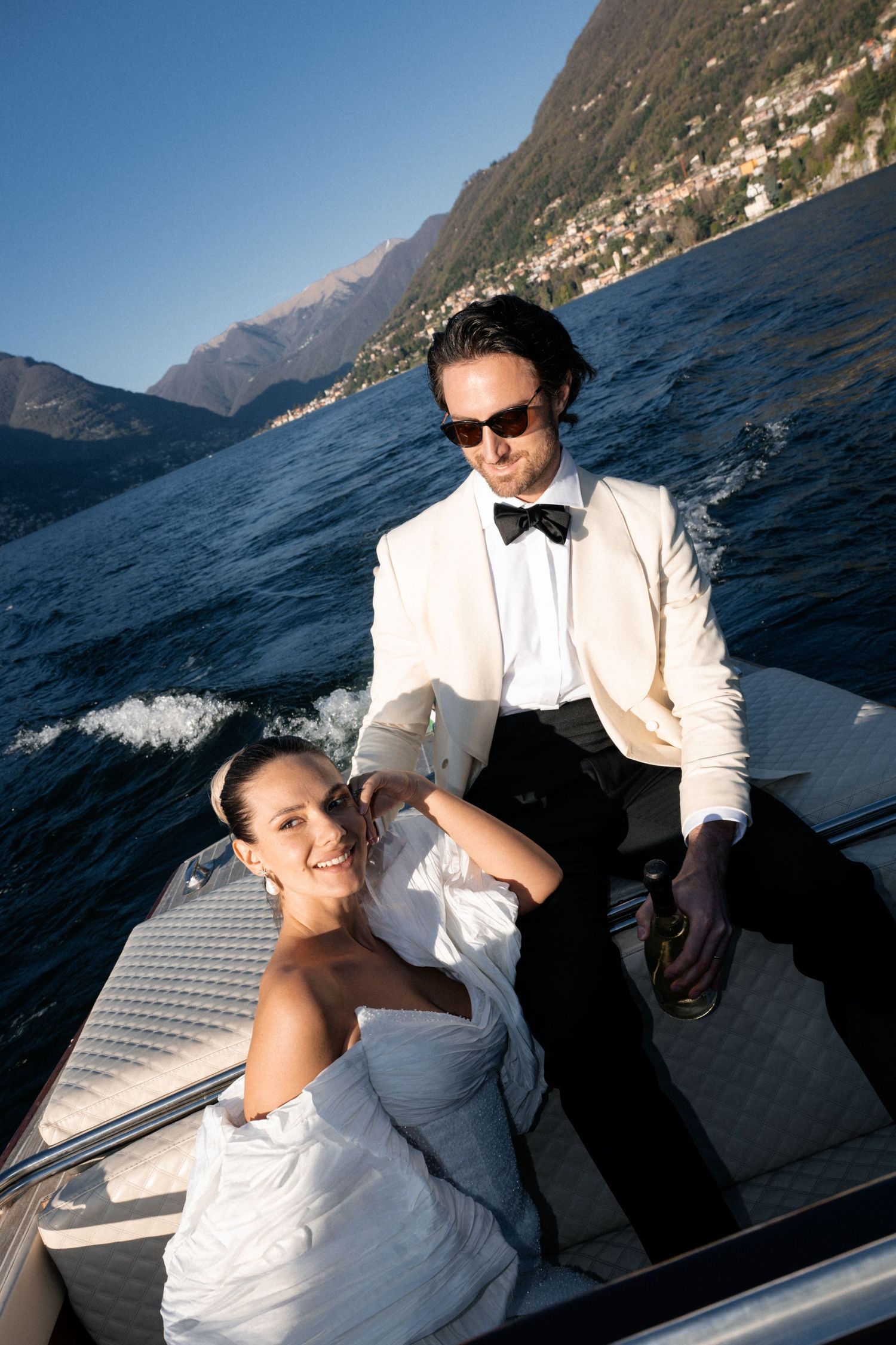A couple shares a special engagement moment on a scenic cliffside overlooking a misty bay.