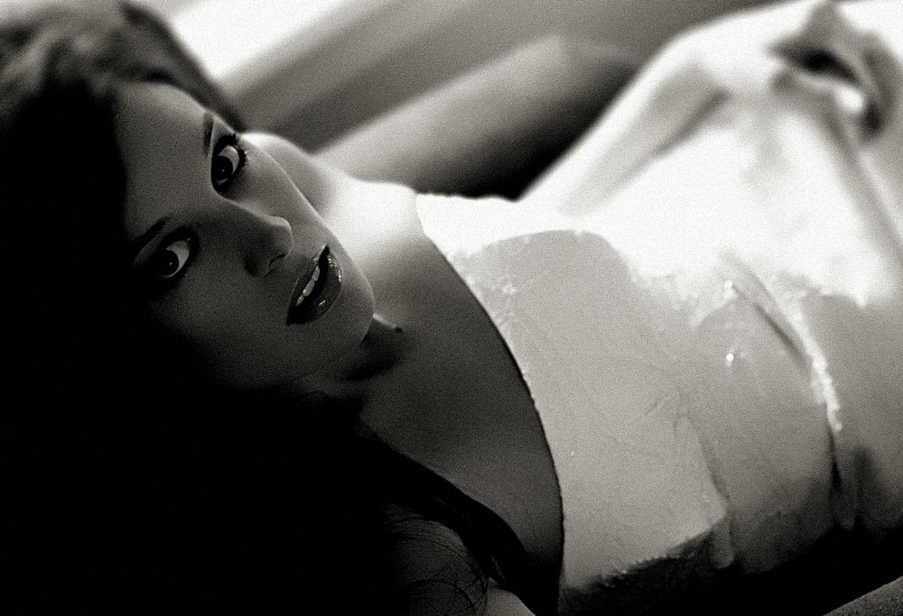 An intimate black and white bridal portrait with soft lighting and delicate details.