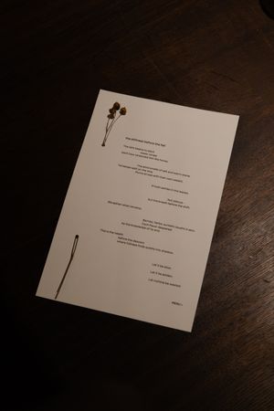 Restaurant menu card with minimalist design layout placed on dark wooden table.