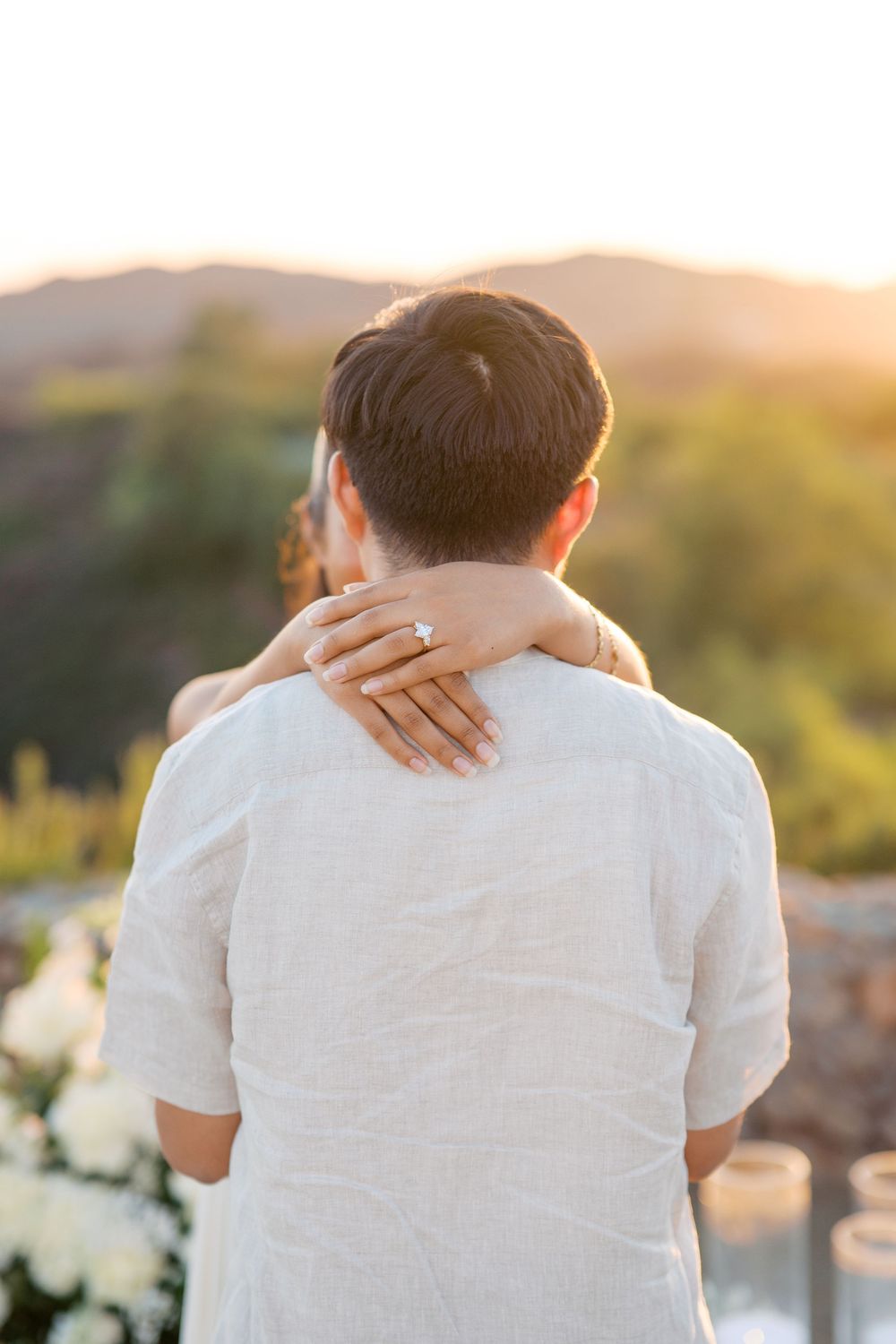 A series of intimate back view shots showing an embracing couple against a golden sunset backdrop.