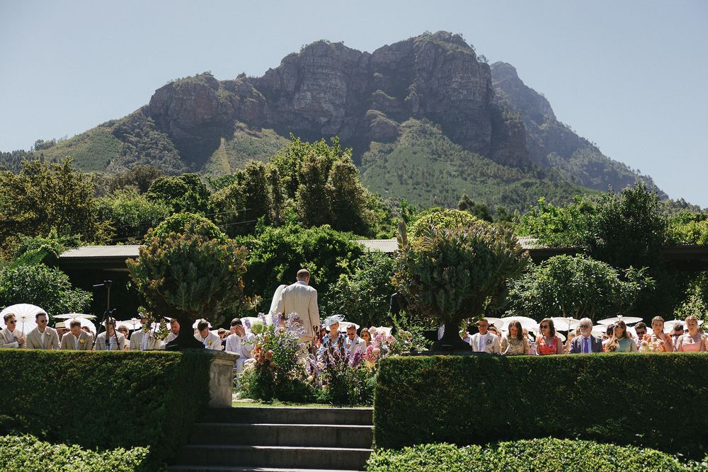 Outdoor ceremony setup at Johannesdal 1207 with white chairs and floral aisle