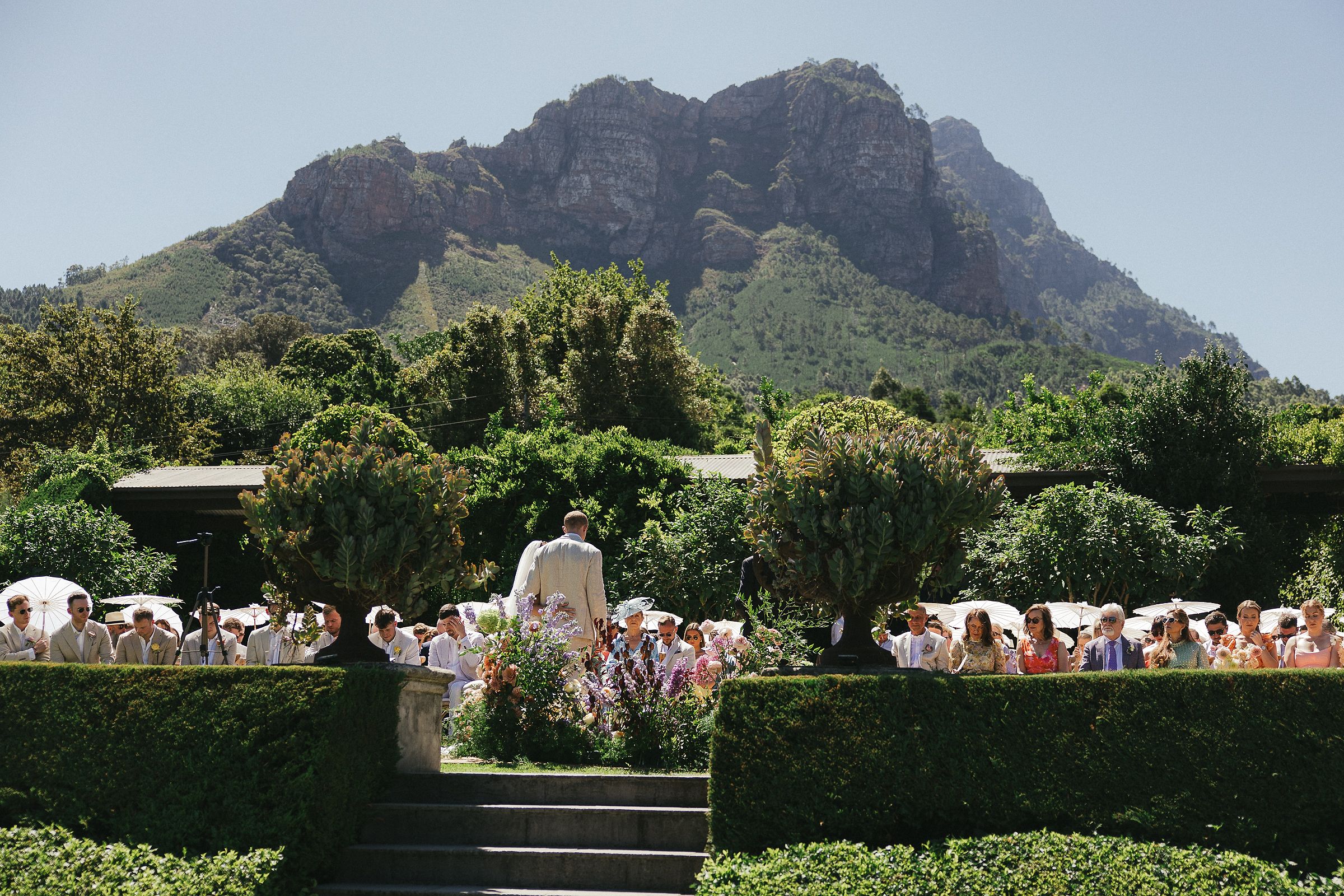 Outdoor ceremony setup at Johannesdal 1207 with white chairs and floral aisle
