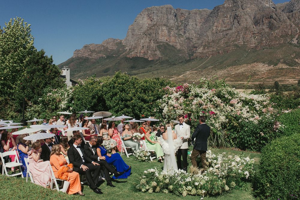 Outdoor ceremony setup at Johannesdal 1207 with white chairs and floral aisle