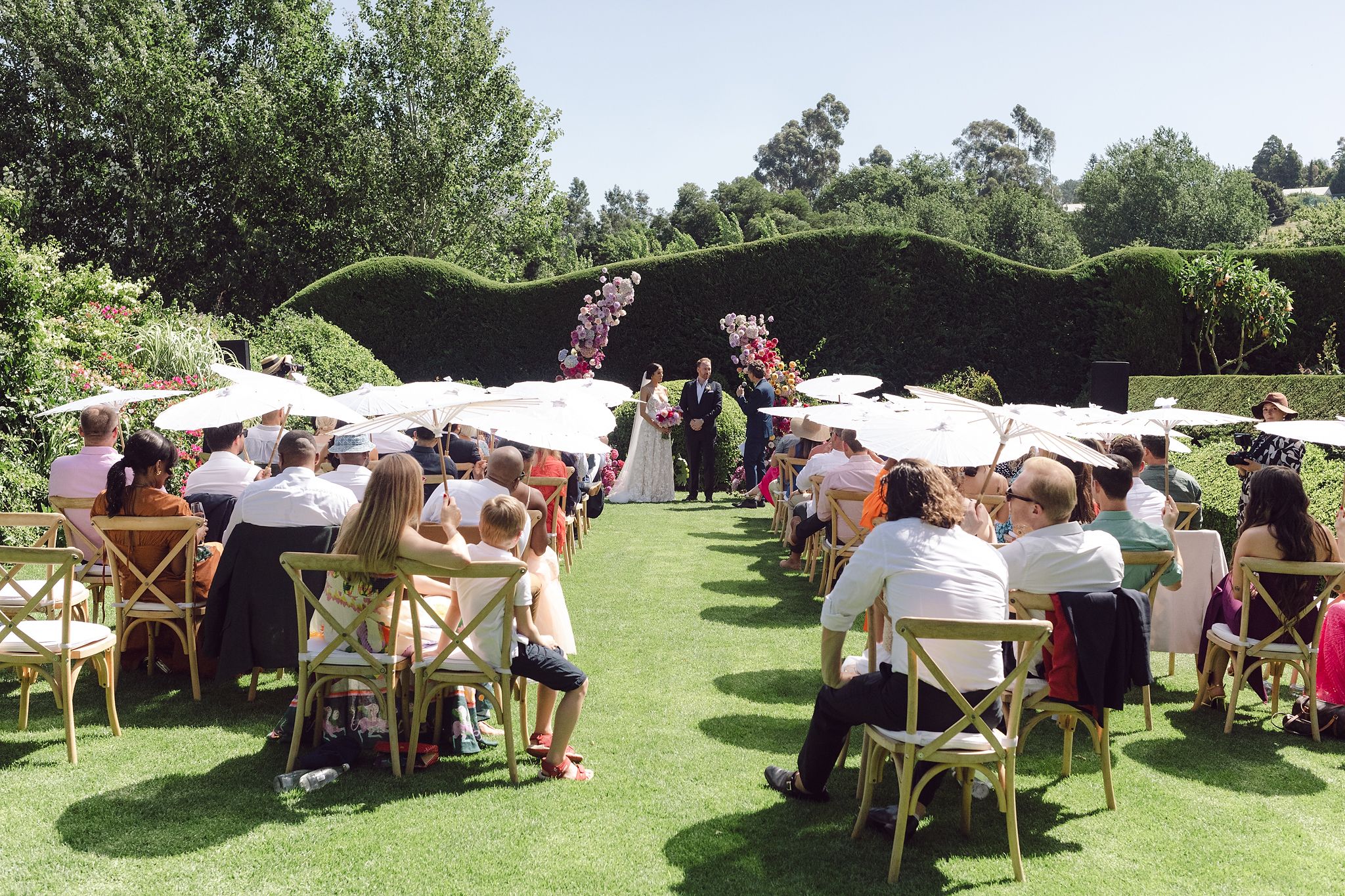 Outdoor ceremony setup at Johannesdal 1207 with white chairs and floral aisle