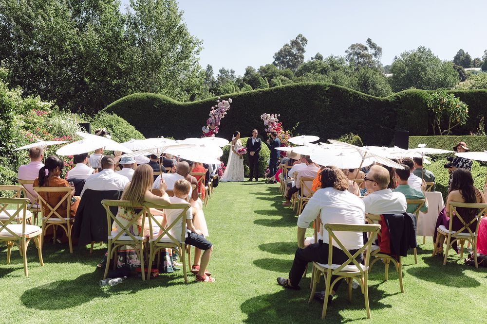 Outdoor ceremony setup at Johannesdal 1207 with white chairs and floral aisle