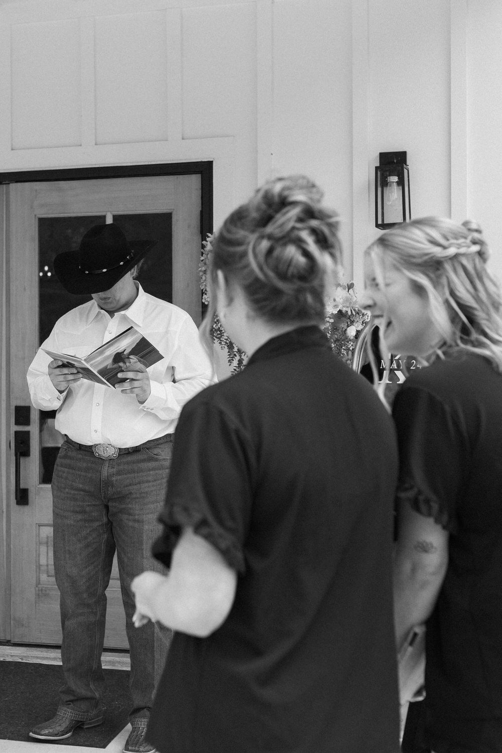 groom looking at custom photo album of bride on north georgia wedding day