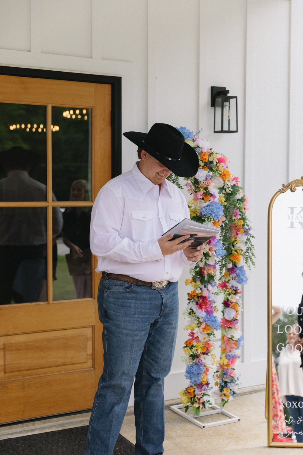 Groom looking at a custom photo album of his bride on his north georgia wedding day