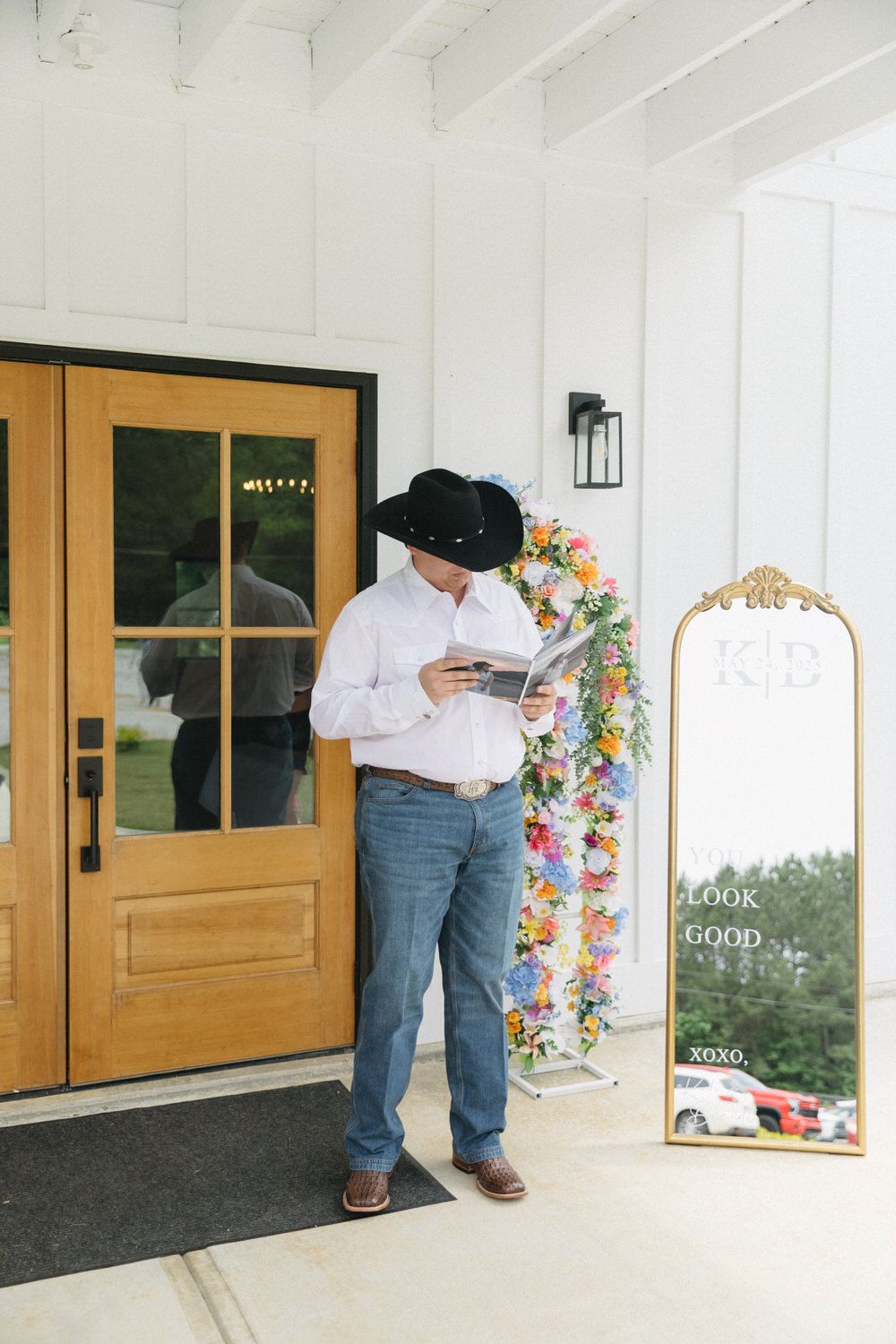 Groom looking at a custom photo album of his bride on his north georgia wedding day