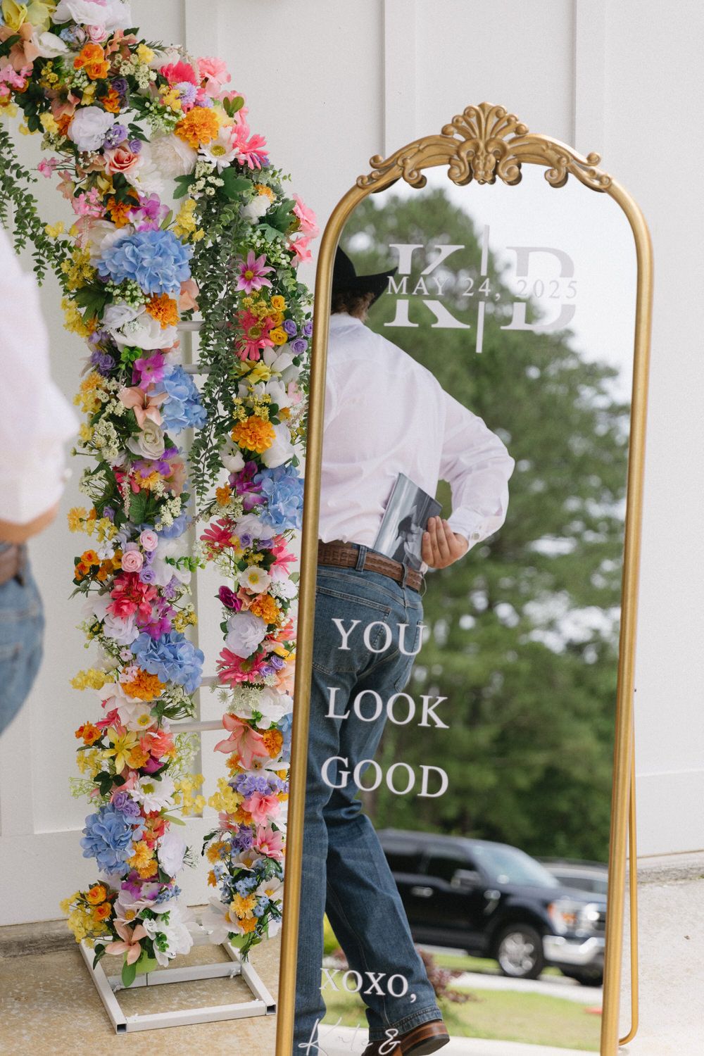 Groom tucking photo album of bride away behind his belt