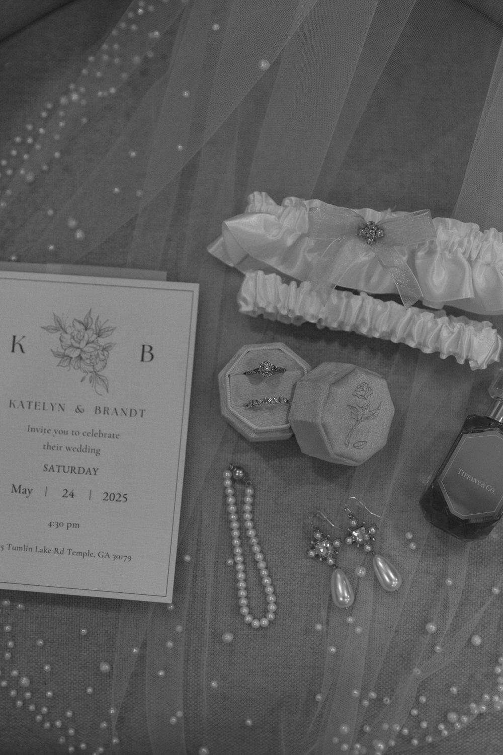 Black and white photo of wedding detail flatlay