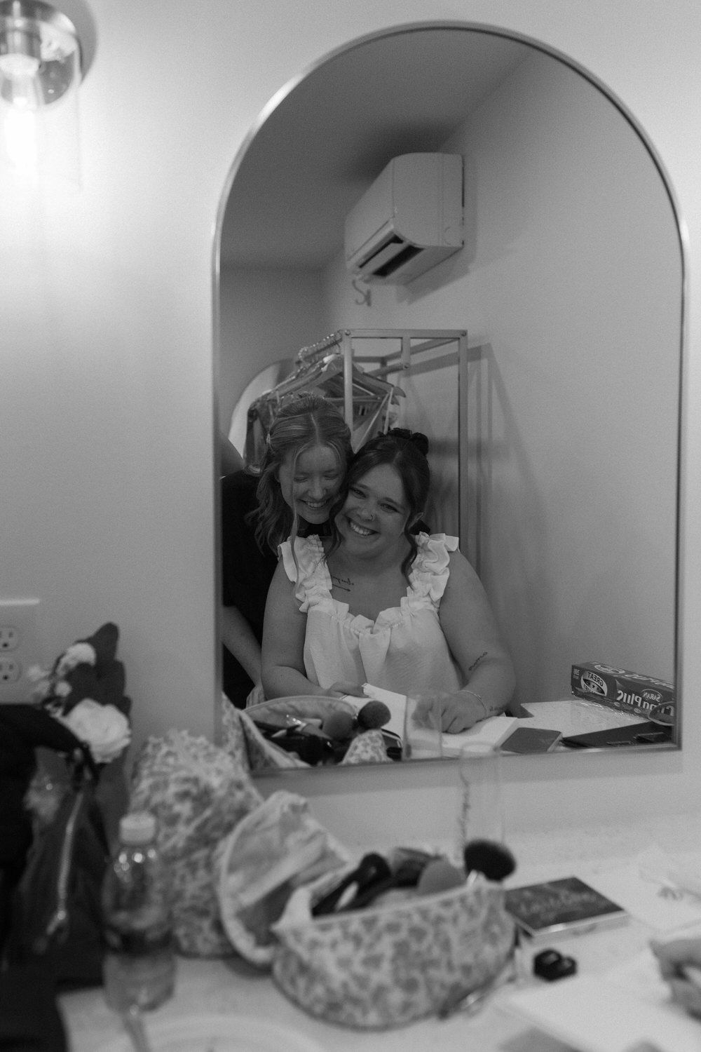 Bride and her maid of honor hugging on her north georgia wedding day