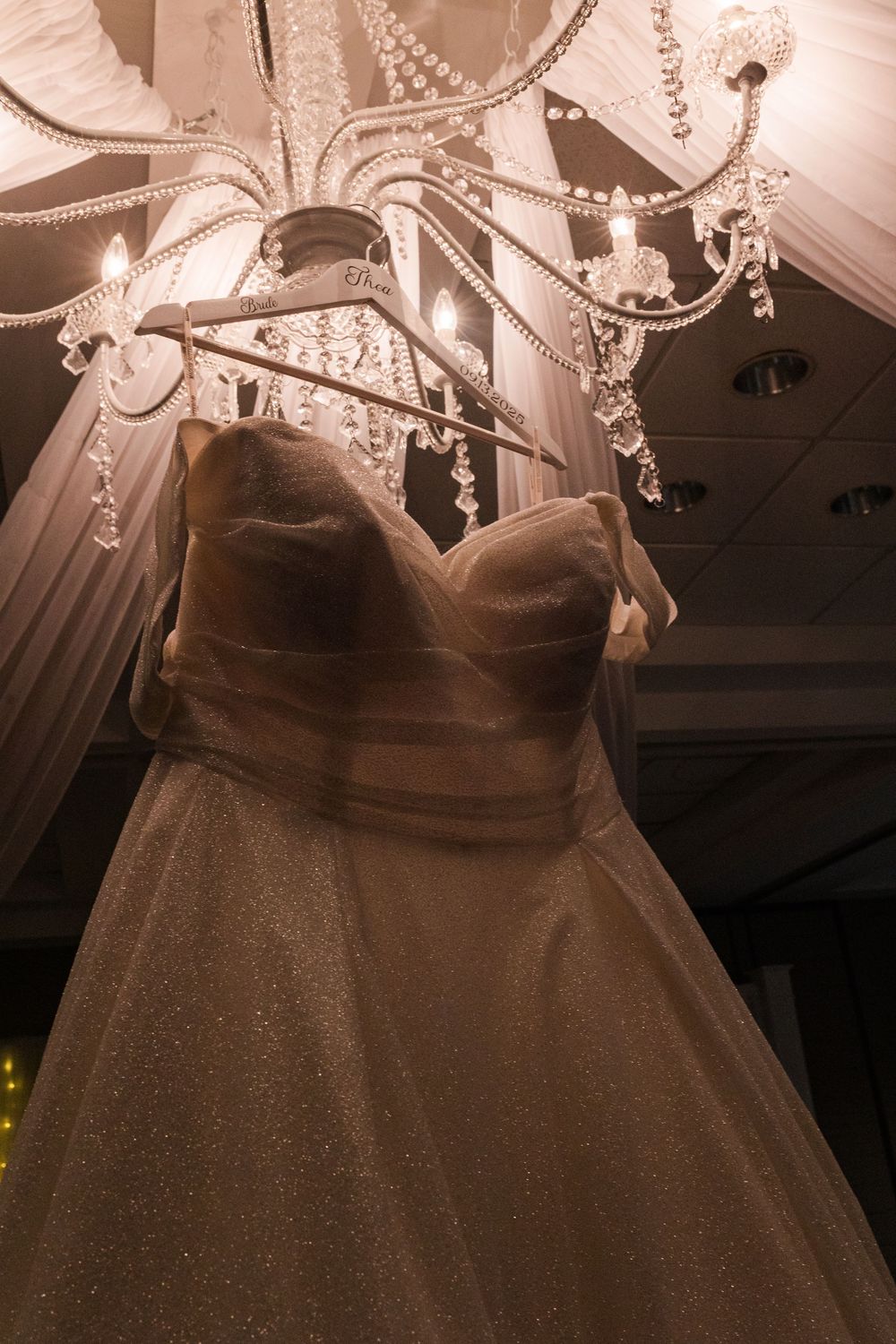 Elegant crystal chandeliers hanging from the ceiling create a luxurious ambiance in a dimly lit interior space.