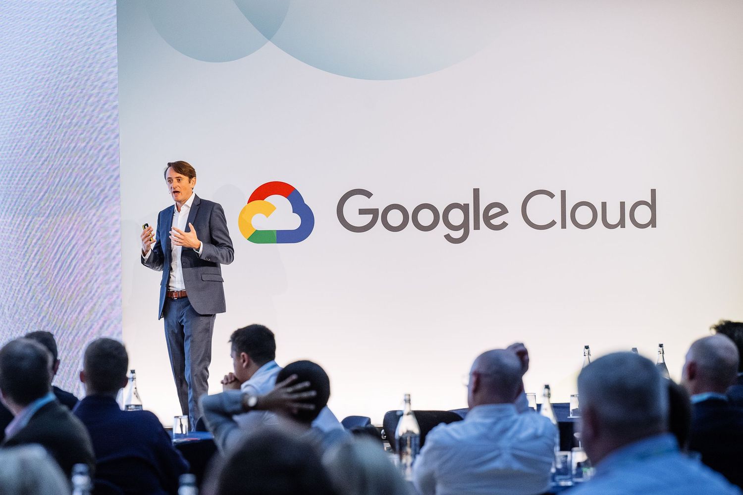 Google Cloud logo displayed on presentation screen at business conference.