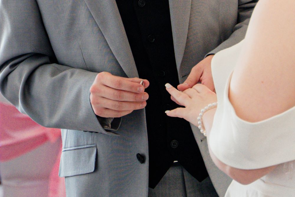 Wedding couple sharing intimate moments in formal attire.