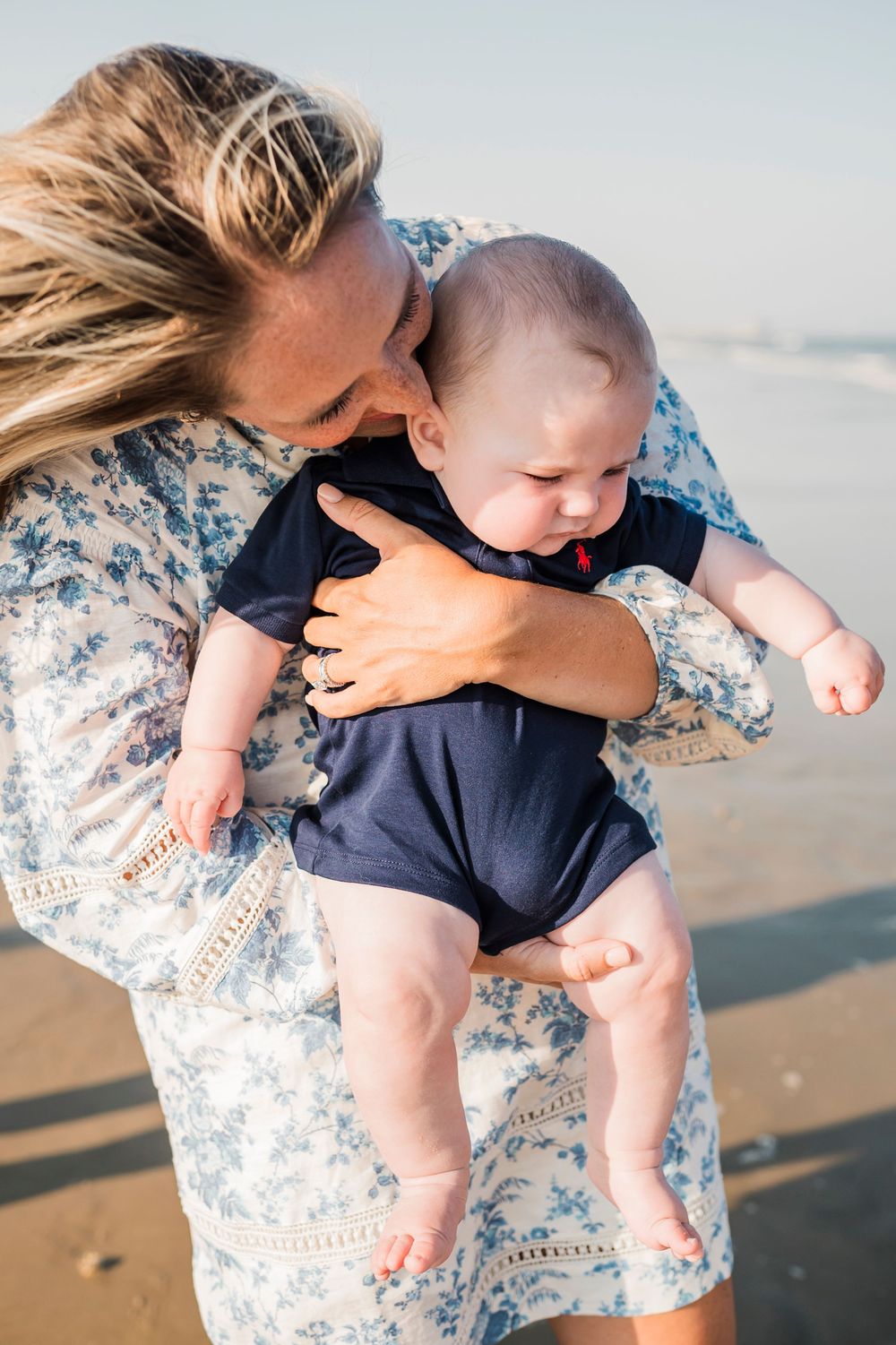 Sweet candid moments captured of playtime and cuddles on a sunny beach.