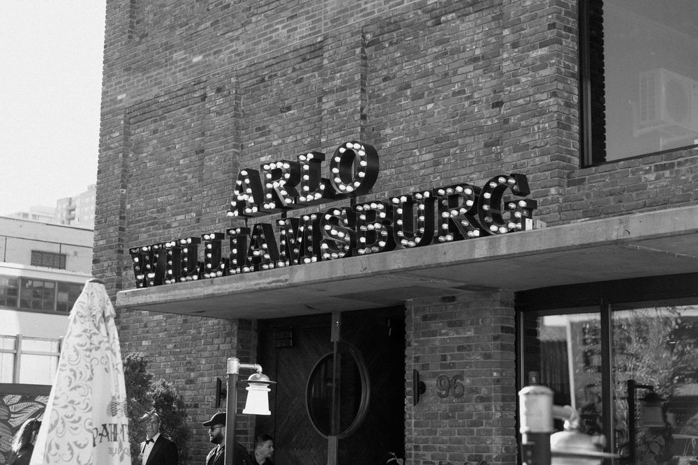 Brick building exterior with vintage-style illuminated signage.