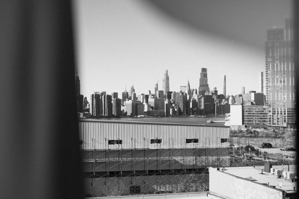 Black and white urban skyline view with modern buildings and rooftops.