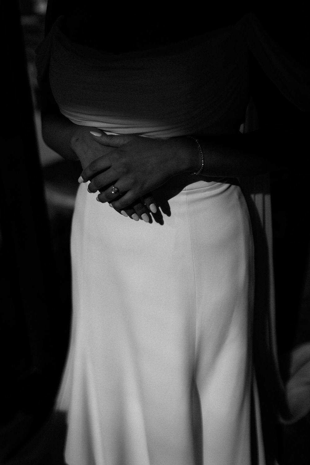Elegant white fabric detail in dramatic black and white lighting.