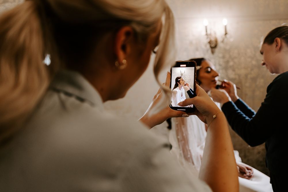 Wedding preparation scene showing intimate getting ready moments in a soft, warm-toned room.