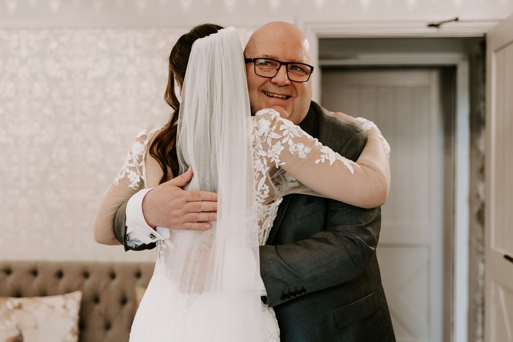 A tender moment shared between two people during a wedding celebration with soft lighting.