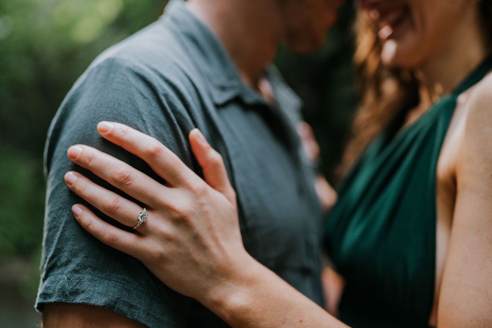 A close-up shot captures an intimate moment between a couple in casual attire.