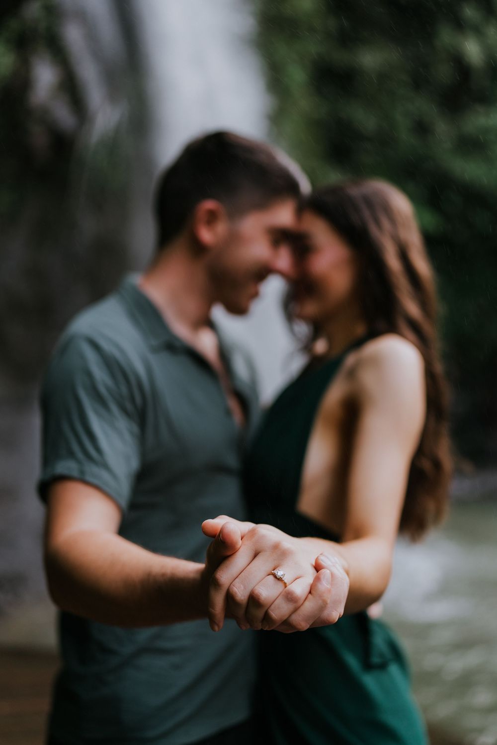 Close-up shots of a couple embracing with a waterfall in the background.
