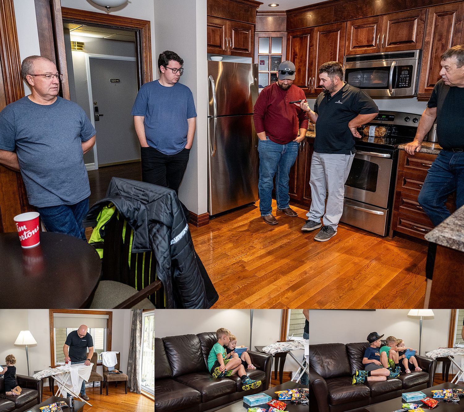 A casual gathering of friends talking in a modern kitchen and lounging on a dark leather couch in a living room.