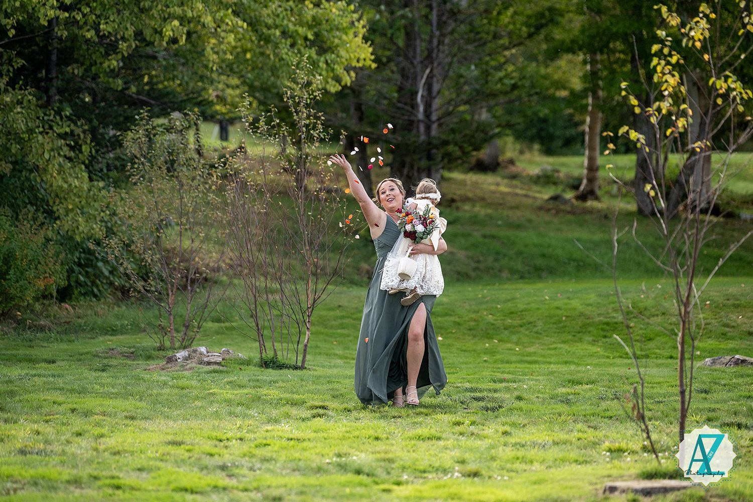 A couple poses for photos in a peaceful park setting with golden sunlight filtering through the trees.