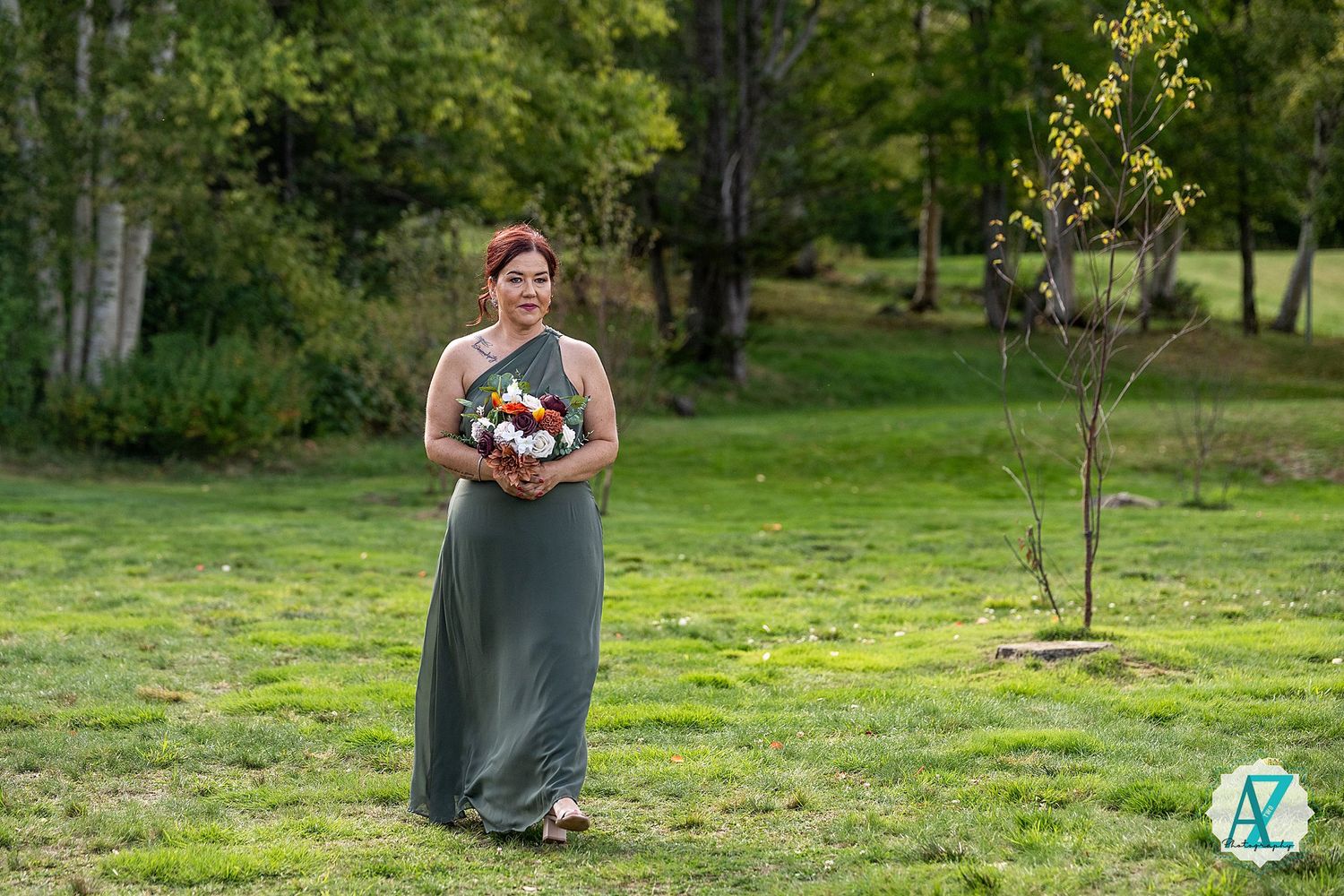 A green outdoor lawn space with scattered wildflowers and natural landscaping elements.