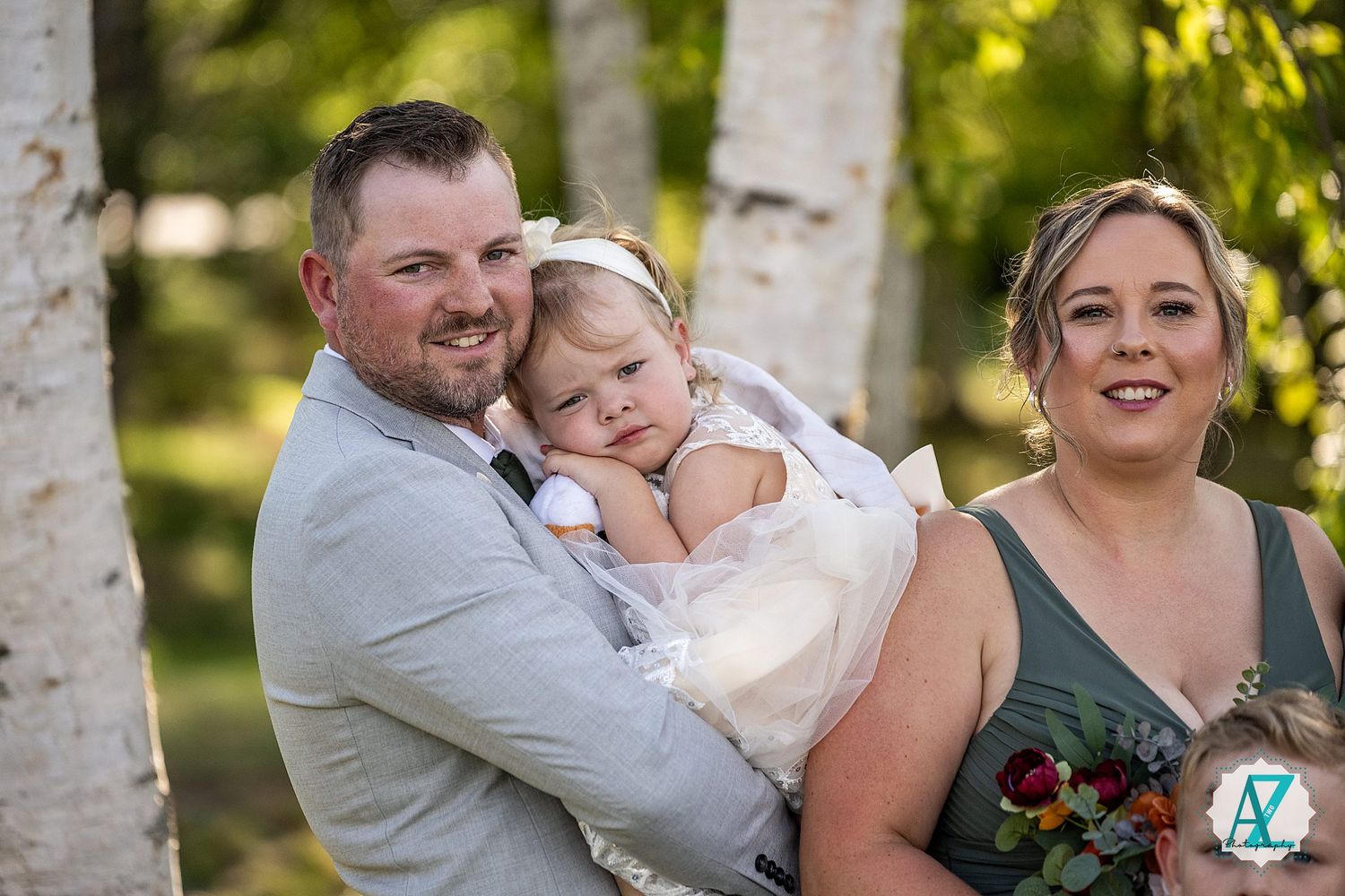Wedding couple shares intimate moments during outdoor photo session among white birch trees.