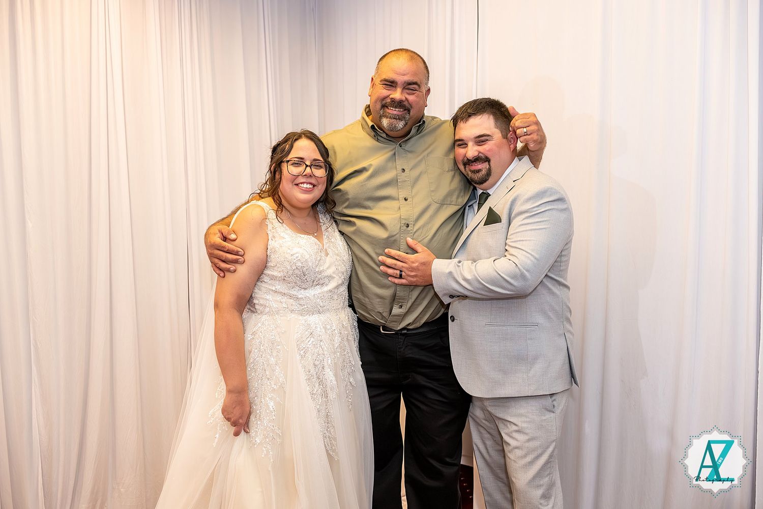 Wedding party members pose together in formal attire at a celebration venue.