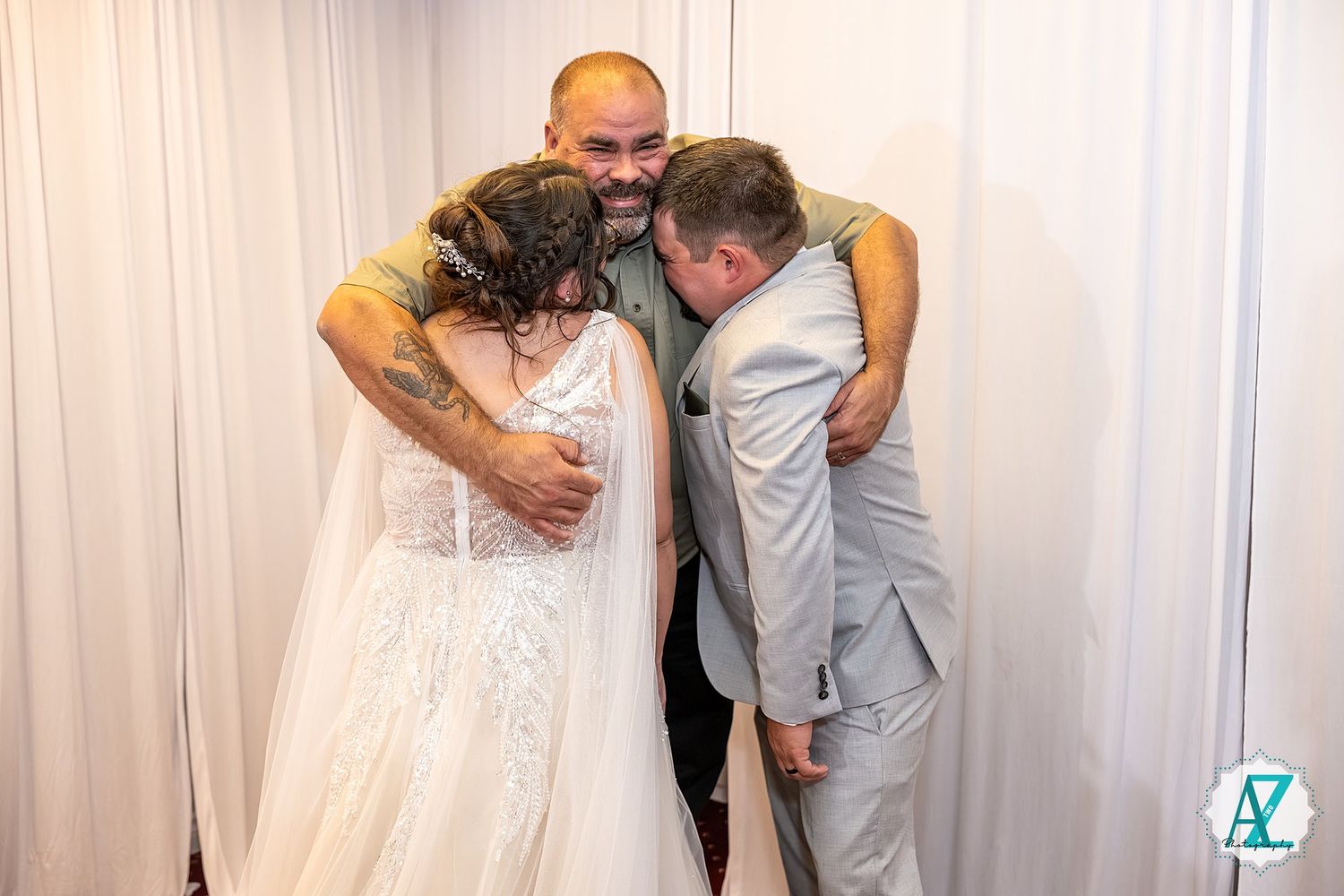 Wedding party members share a candid laughing moment while posing for group photos in formal attire.