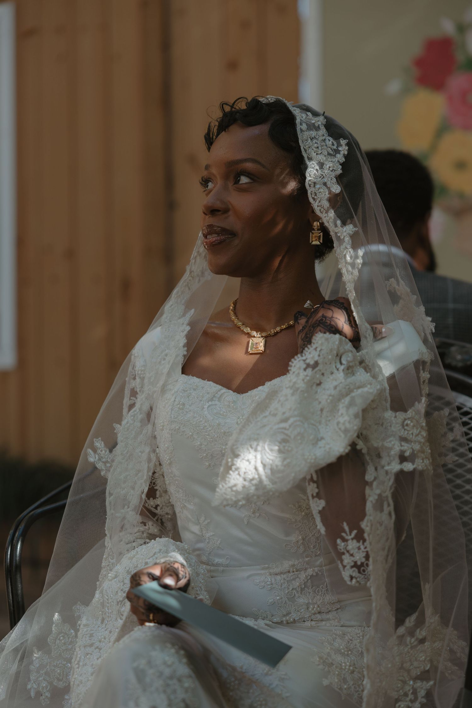 A bride in a beautiful white lace wedding dress and veil is shown in a series of candid moments during her special day.