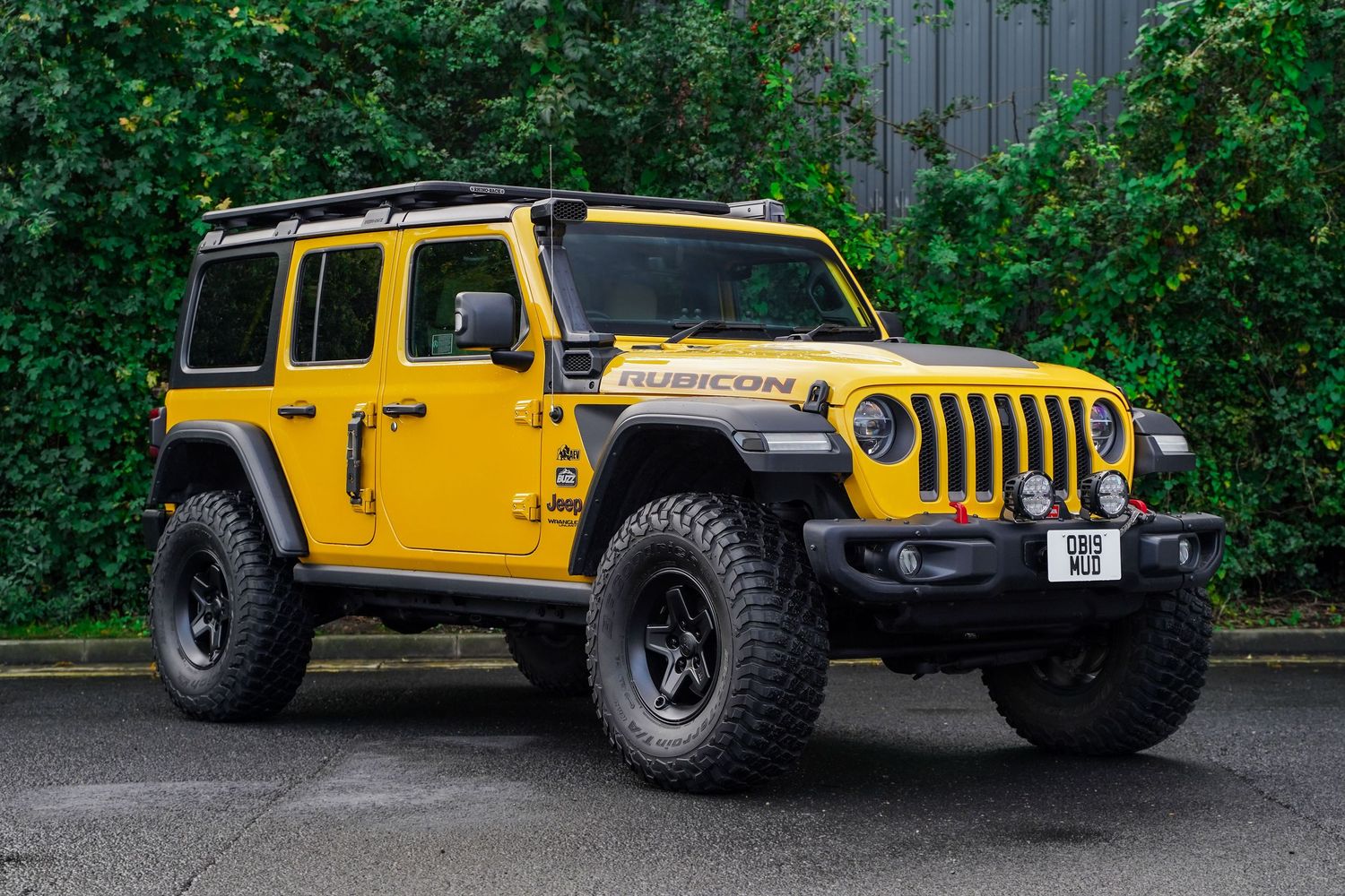 Yellow Jeep Wrangler Rubicon photographed from multiple angles against green foliage background.