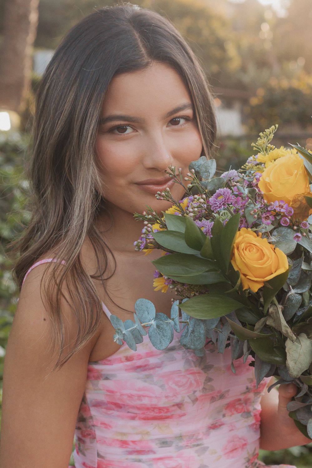 A series of photos showing someone holding a beautiful bouquet of yellow roses and purple flowers at sunset.